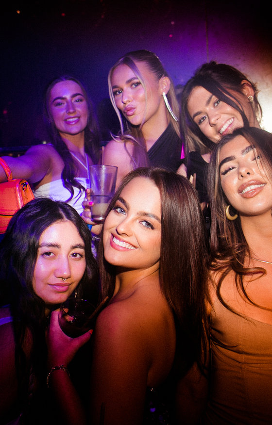 Four women dressed up in a nightclub